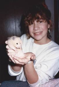 This is me with my hamster "Fluffy Chumpster"  Fluffy Chumpster was pregnant when I got her from the petstore (surprise!) and he had several babies which were fun and a bunch of my friends in grade school adopted them.  
